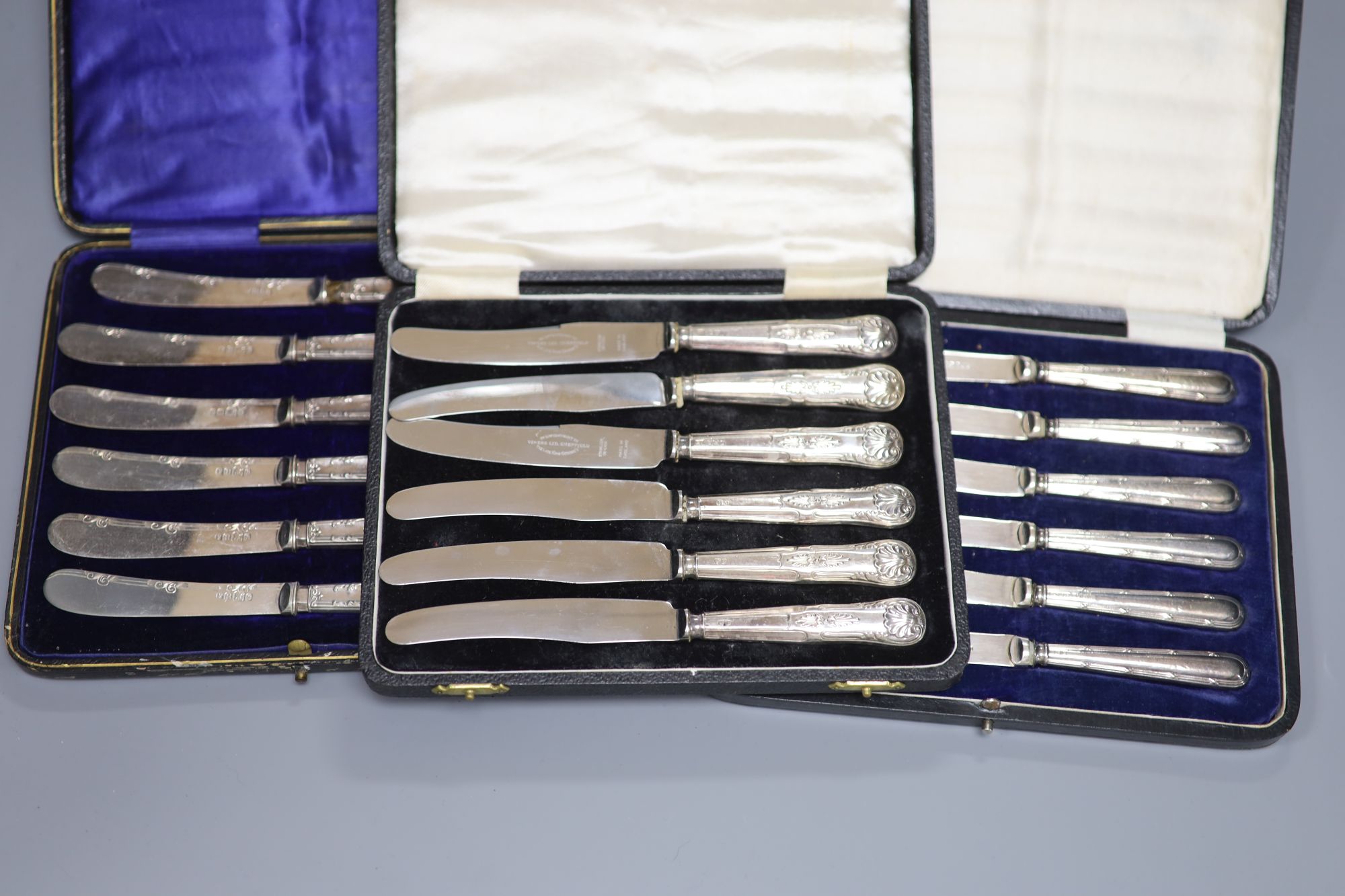 Seven assorted cased sets of silver handled tea knives including pistol handled.